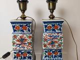 two blue and white vases with flowers on them