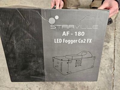 someone is holding a box with a light inside of it