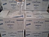 several boxes of carton dor on a wooden table with a glass on top