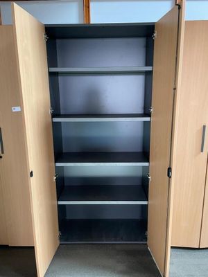 a tall wooden cabinet with two doors open