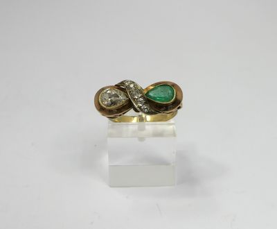 a gold ring with a green stone and two diamonds