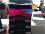 a stack of folders sitting on a desk next to a computer