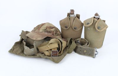 three canteens, a hat, a belt, and other items are sitting on a white surface