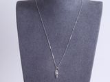 a silver necklace with a leaf pendant on a mannequin neck