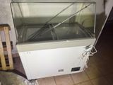 a glass display case sitting on top of a white cabinet
