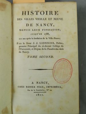 an open book with a stamp on it sitting on a table