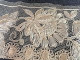 a close up of a piece of lace with flowers on it