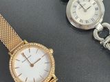 an image of two ladies ' s wrist watches on a black surface