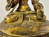 a statue of a woman sitting on a pedestal