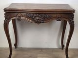 an old wooden table with a marble top and carved legs