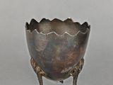 an image of a metal object with a bird ' s feet on it