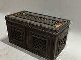 an old wooden box with intricate carvings on the sides