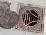 a metal drain with a hole in the middle of it