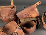 several pieces of leather are sitting next to each other on a table