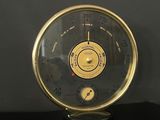 a black and gold clock sitting on a black table