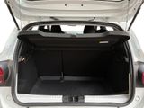 the back of a white car with its trunk open