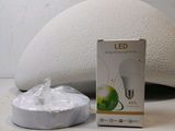 a white light bulb sitting next to a box of white stuff