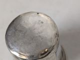 silver plated salt and pepper shaker on a white counter top