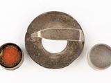 a small metal object with a red substance in it