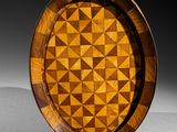 an image of a wooden plate with a geometric design on it