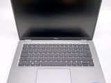 an open laptop computer sitting on top of a white table