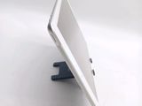 a white tablet computer sitting on top of a white table