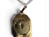 gold plated pendant with a picture of a man in a circle