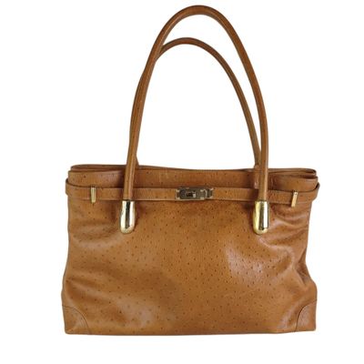 an image of a brown purse with a gold handle