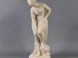 a statue of a woman with a dog on her lap