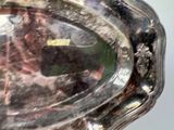a silver tray with a picture of a man and a dog on it