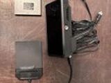 a cell phone, a charger, and a charger sitting on a table
