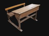 a small wooden desk with a chair on it