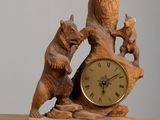 a clock that is sitting on a table with bears on it