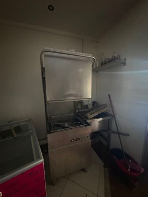 a small kitchen with a stove, sink, and refrigerator