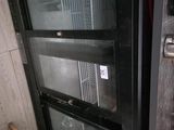 a glass door that is open on the side of a building