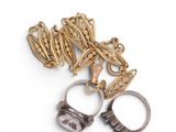 two pairs of rings and a chain on a white surface