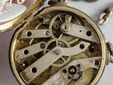 a close up of a pocket watch with a chain around it