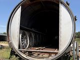 a large barrel sitting in the middle of a field