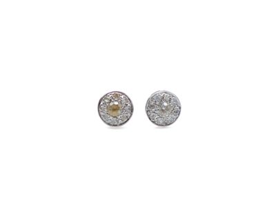 a pair of diamond stud earrings on a white background