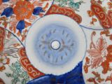 a close up of a plate with a flower design on it