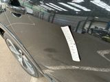 a sticker on the door of a car that is parked in a parking lot