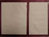 a red folder with two papers on it sitting on a table
