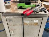 une armoire métallique sur laquelle sont posés des outils, dans un garage