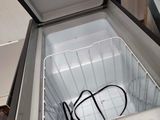 a small refrigerator with a door open on the floor