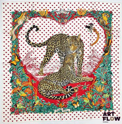 un tableau représentant un léopard assis sur un coussin rouge
