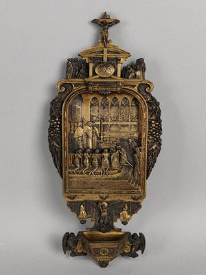une image représentant une horloge en or sur laquelle figurent un homme et une femme
