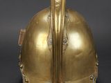 an antique brass helmet with a long nose and a long nose