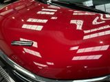 a red car that is parked in a showroom