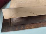 a knife that is sitting on top of a piece of wood