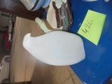 a blue table with a white vase and a yellow post it note on it